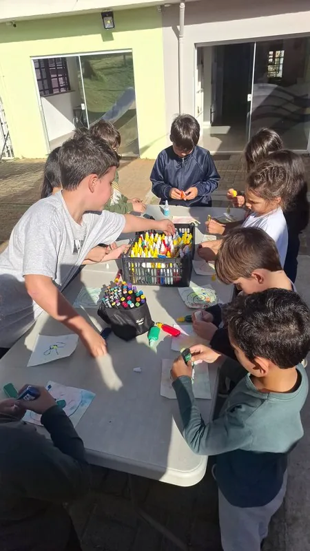 Estudantes do Fundamental 1 colaboram em projeto em grupo com materiais de arte na Escola Lumiar Poços de Caldas